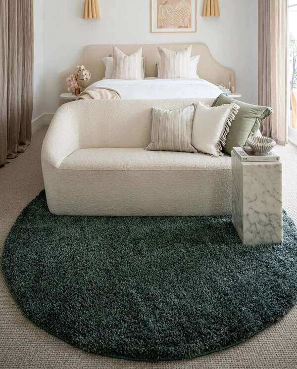 Round rug in a bedroom.