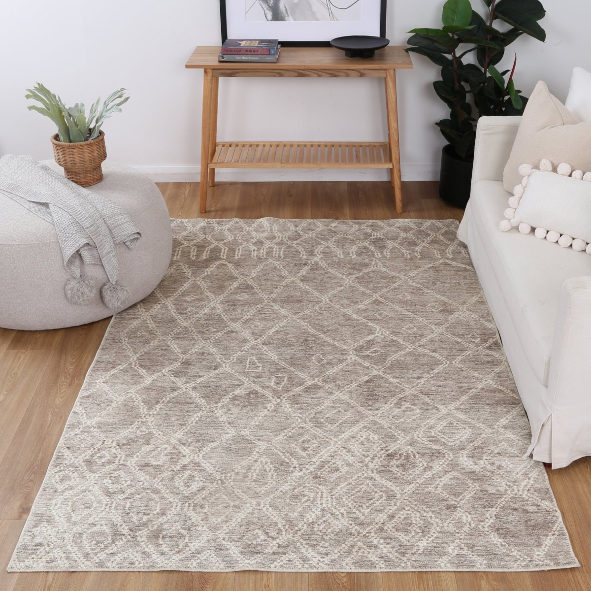 Close-up of a beige rug with gold and taupe accents, featuring NanoWipe technology for easy cleaning and a Fur_riendlyâ„¢ coating to reduce allergens.